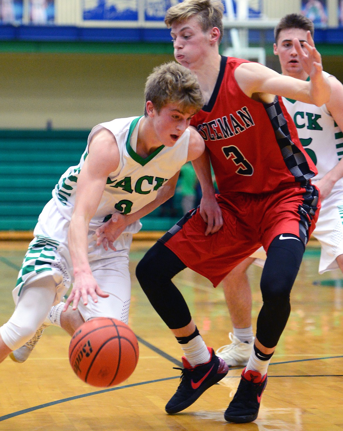 Glacier's Caden Harkins dribbles around Bozeman defender Ryan Simpson. (Casey Kreider/Daily Inter Lake)