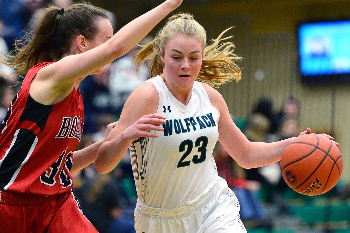 Glacier's Anna Schrade dribbles to the hoop with Bozeman's Alex Carey defending. (Casey Kreider/Daily Inter Lake)