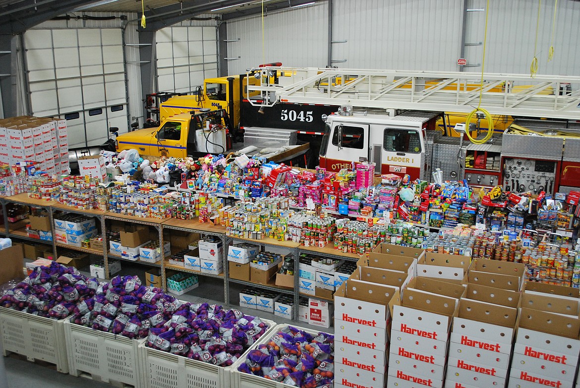 Bob Kirkpatrick/The Sun Tribune - The shelves and aisles at the Othello Fire Station were chock-full of canned goods, toys and bags of produce and fruit.