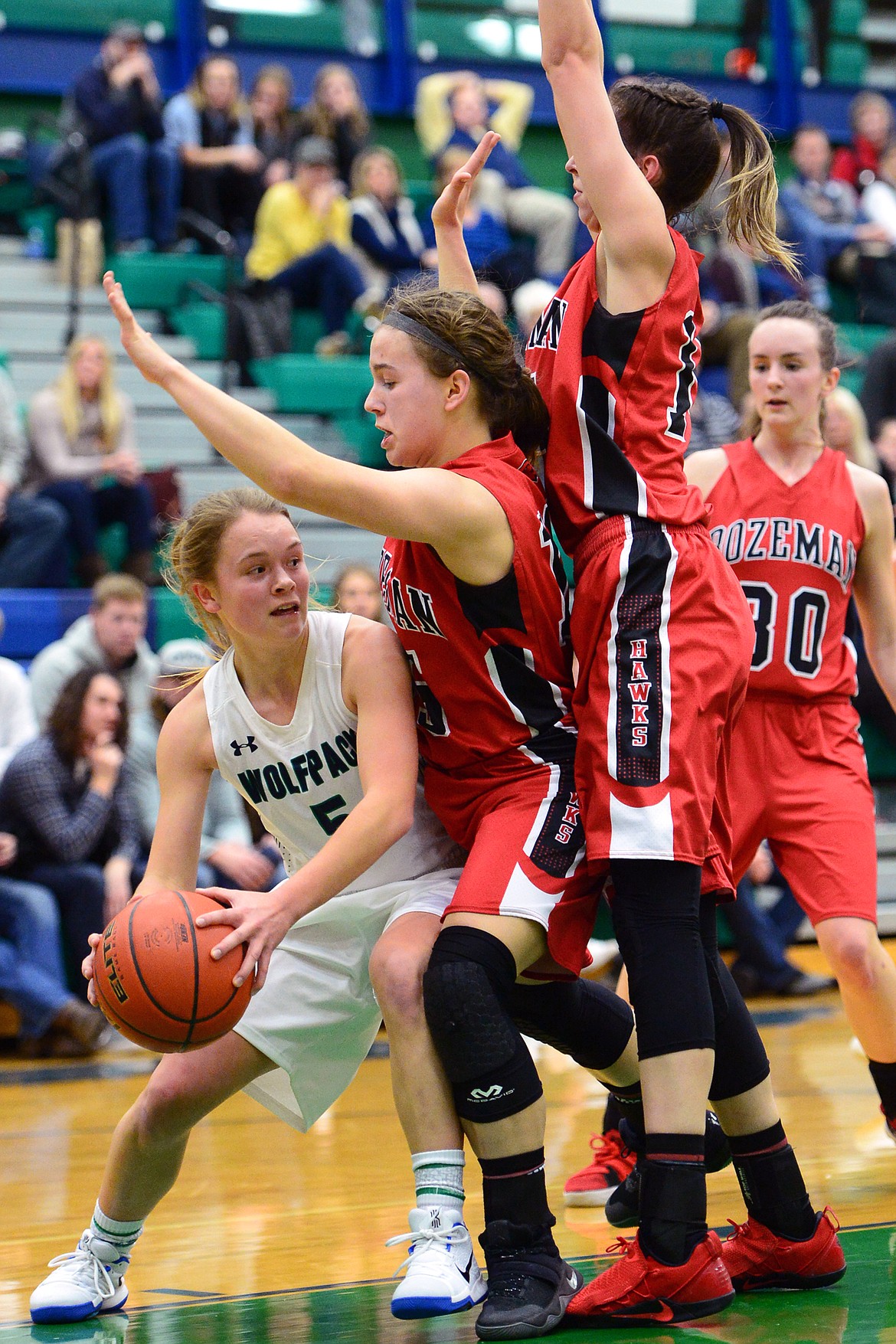 Glacier's Cadie Williams looks to pass around Bozeman defenders Hannah Wheeler, center, and Angelle Diamond, right. (Casey Kreider/Daily Inter Lake)