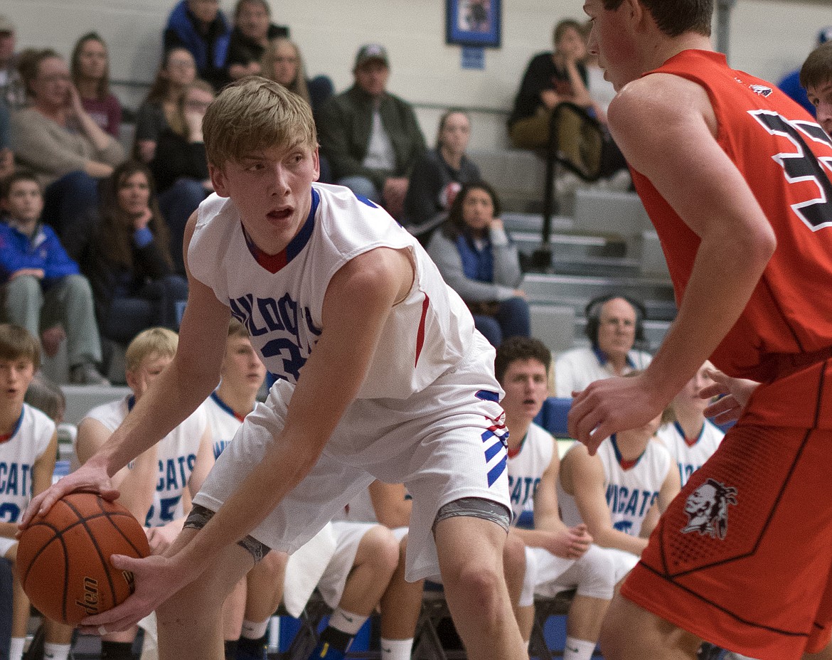 Matt Morrison looks to pass to a teammate against Flathead. (Jeremy Weber photo)