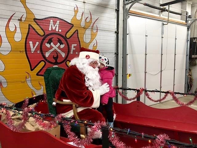 Santa hears the gift wishes of a Mullan girl on the nice list. Nolan said that roughly 80 Silver Valley children attended this year&#146;s event.