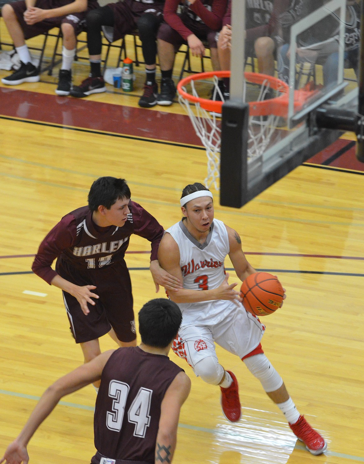 ARLEE WARRIORS guard Will Mesteth drives to the basket against Harlem at the Native American Classic. Mesteth is one of the key components to the Warriors' offensive attack as they prepare to play Plains Thursday night at Plains. (Jason Blasco/Lake County Leader)