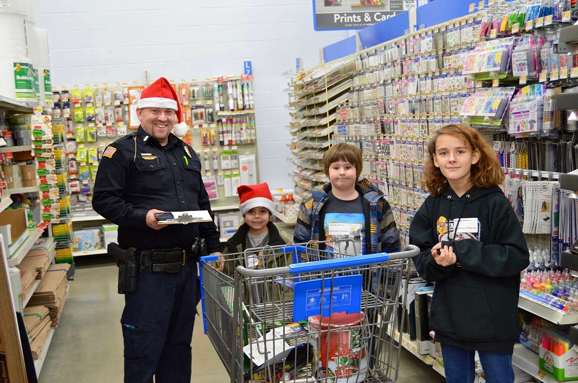 Photo courtesy of OSBURN POLICE DEPARTMENT
OPD officer Jason Woody take his assigned kids down the arts and crafts aisle.