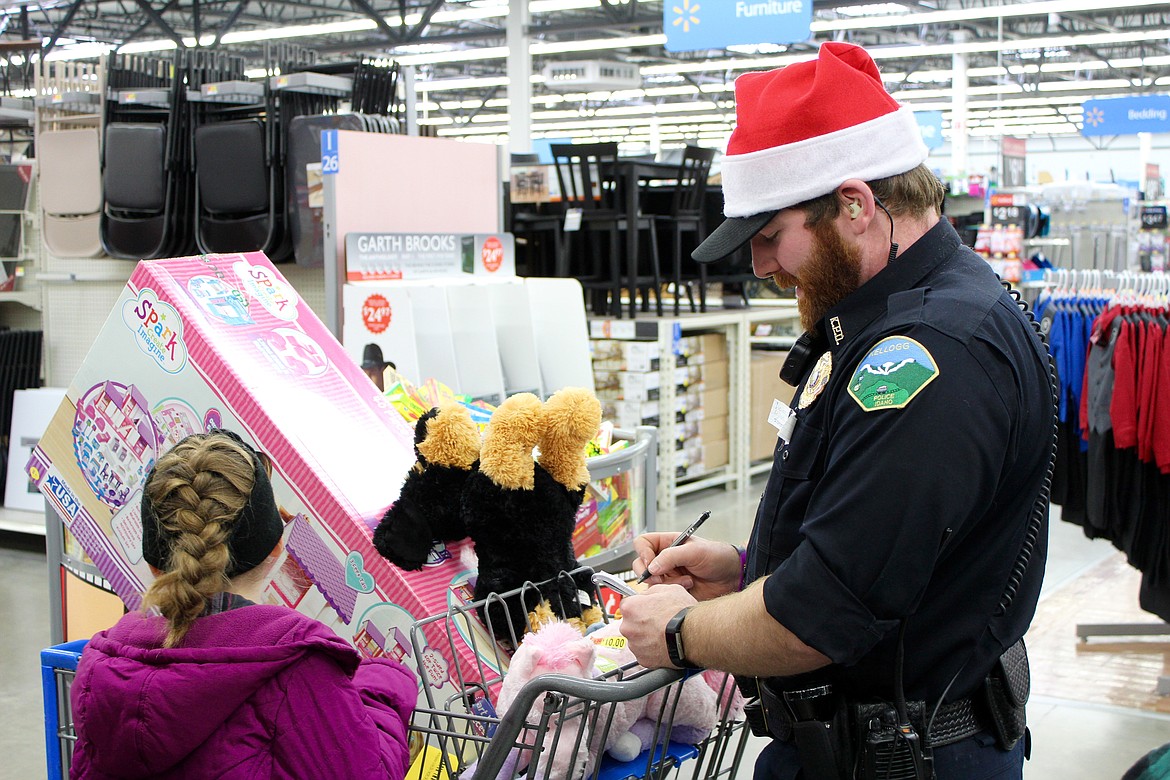 Photo by CHANSE WATSON
Hudson does the math and makes sure that his assigned kids are on budget with their gifts.