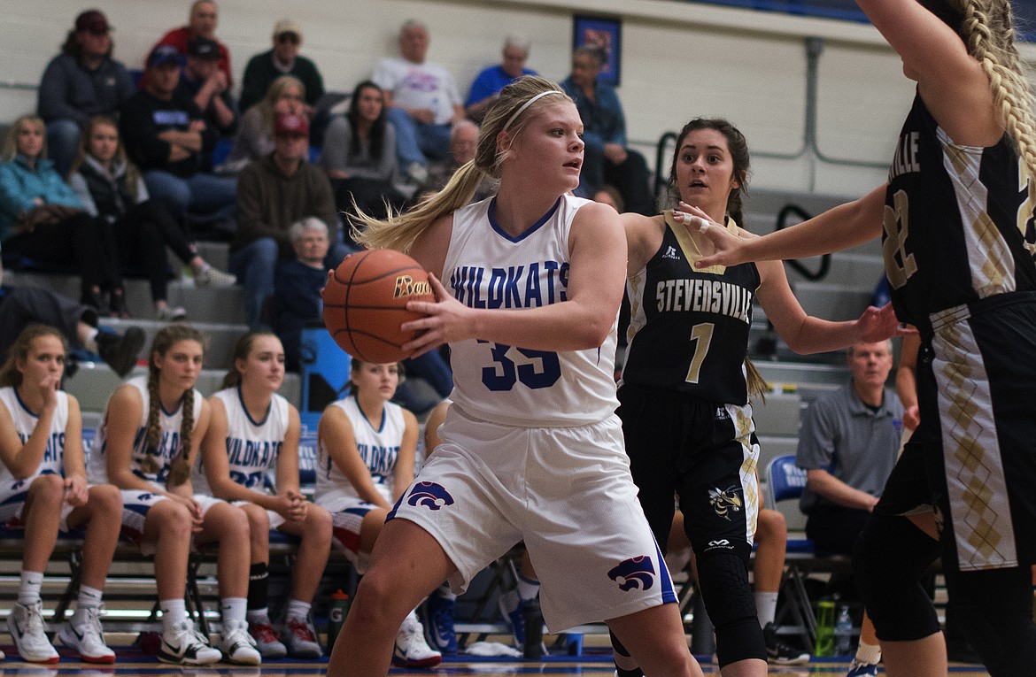 Trista Cowan looks to pass after pulling down a rebound against Stevensville. (Jeremy Weber photo)