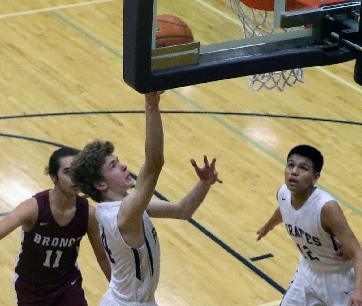 Robin Erickson gets two of his seven points in the conference game against Hamilton Saturday night at Linderman Gym.  (photo by Bob Gunderson/Special to the Lake County Leader)