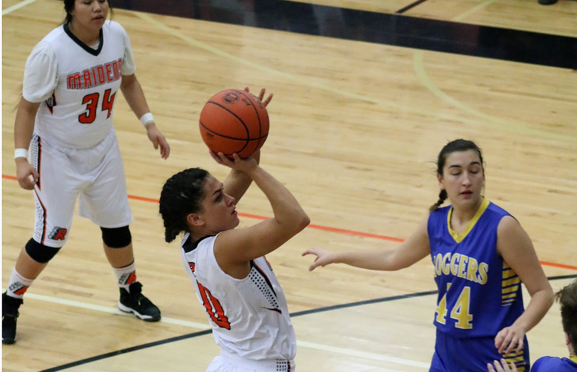 SENIOR GUARD Micalann McCrea shoots over the Libby Loggers defenders in close contest in which the Maidens lost 41-45 Saturday aftenoon at the Ronan Events Center. (Photo by Teagan Gray/Special to the Lake County Leader)