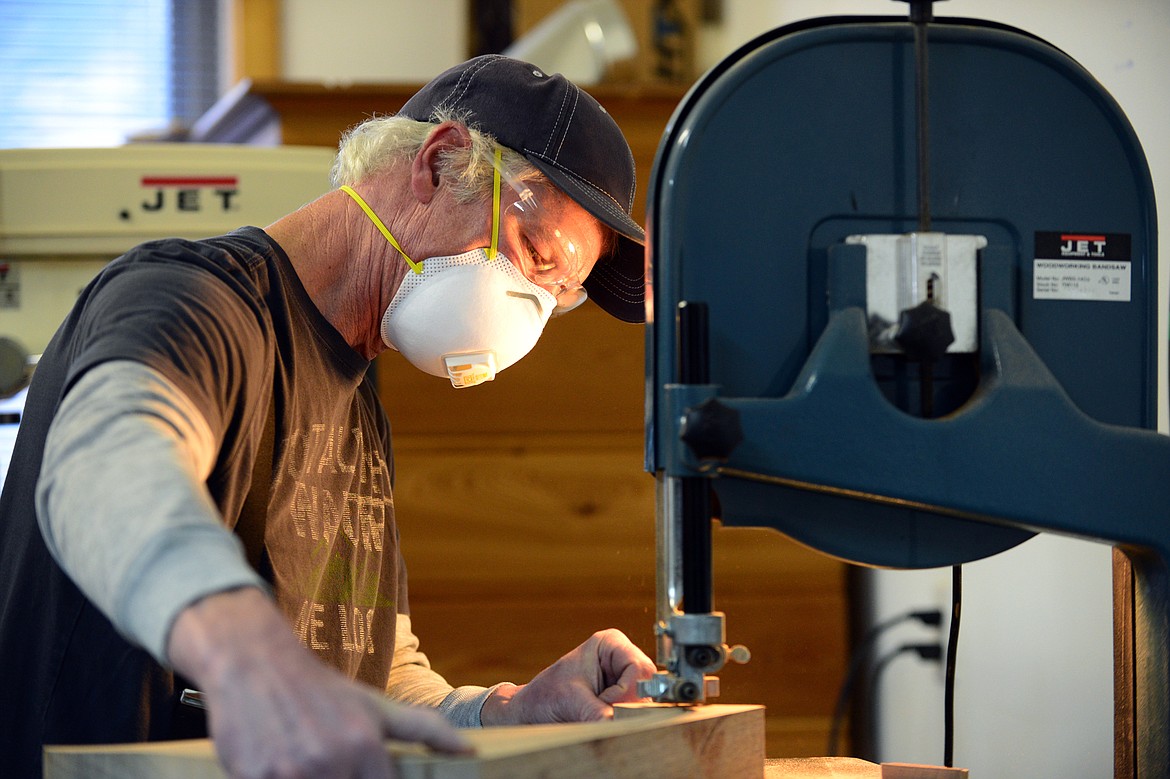 Brent Champion uses a bandsaw to work on Guitar Shoes at his workshop on Wednesday, Nov. 29. (Casey Kreider/Daily Inter Lake)