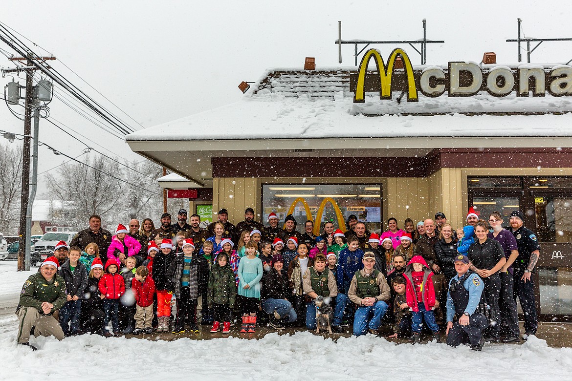 Law enforcement personnel from Lincoln County Sheriff&#146;s Office, Libby and Troy police departments, Montana Highway Patrol, and Fish, Wildlife and Parks, along with volunteers, pose with the kids who participated in Shop With a Cop Tuesday, Dec. 19, 2017. (John Blodgett/The Western News)