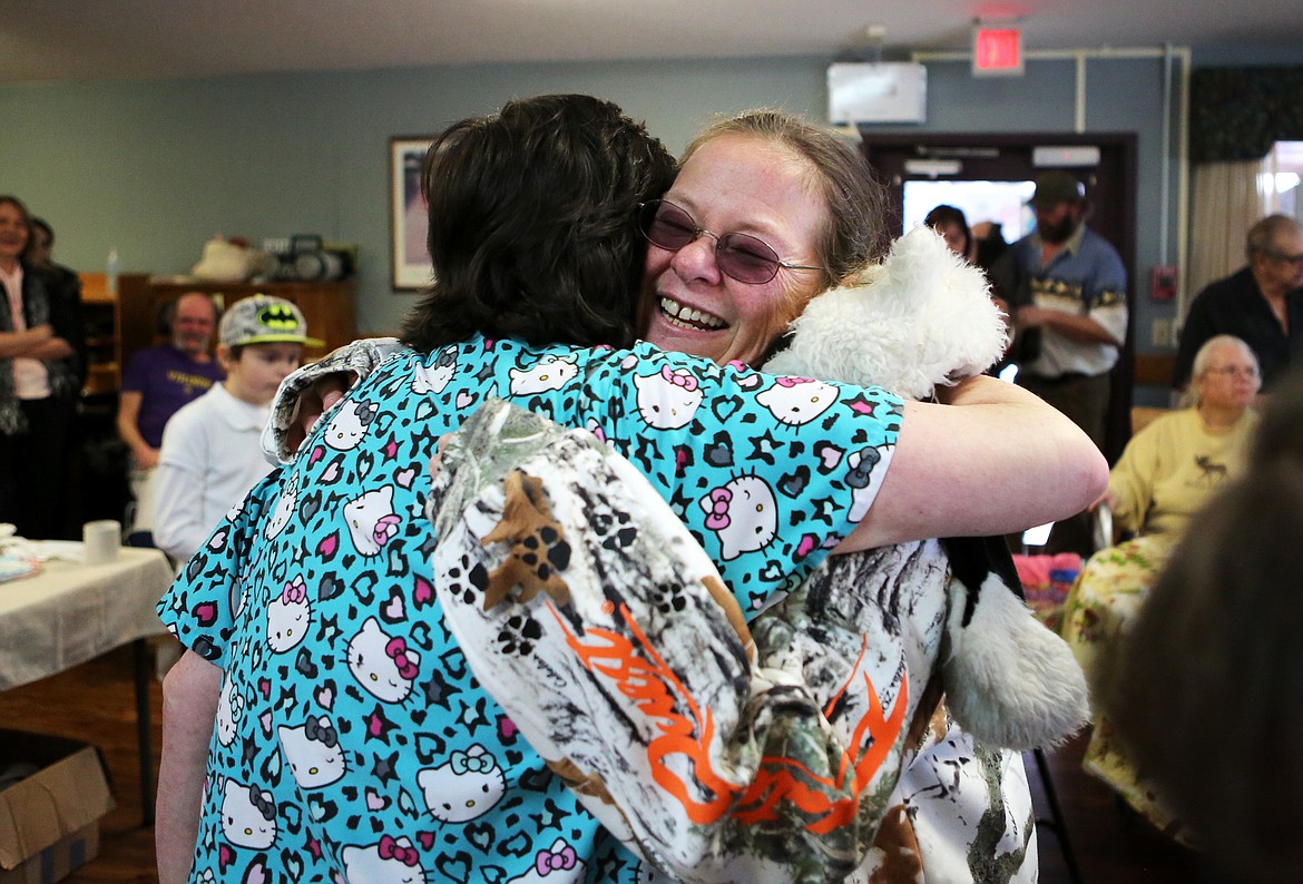 Newlywed Denise Worthington-Sisco, right, hugs co-worker Barbara Bakke after eher wedding ceremony at Lake View Care Center, where she also works as a CNA. (Mackenzie Reiss/Daily Inter Lake)