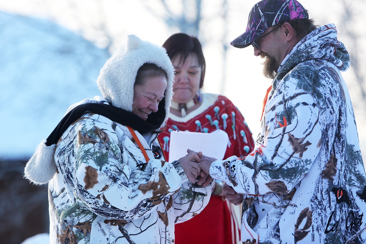 Denise Worthington places a wedding band on Todd Sisco&#146;s finger during their wedding ceremony Sunday morning at Lake View Care Center in Bigfork. (Mackenzie Reiss/Daily Inter Lake)