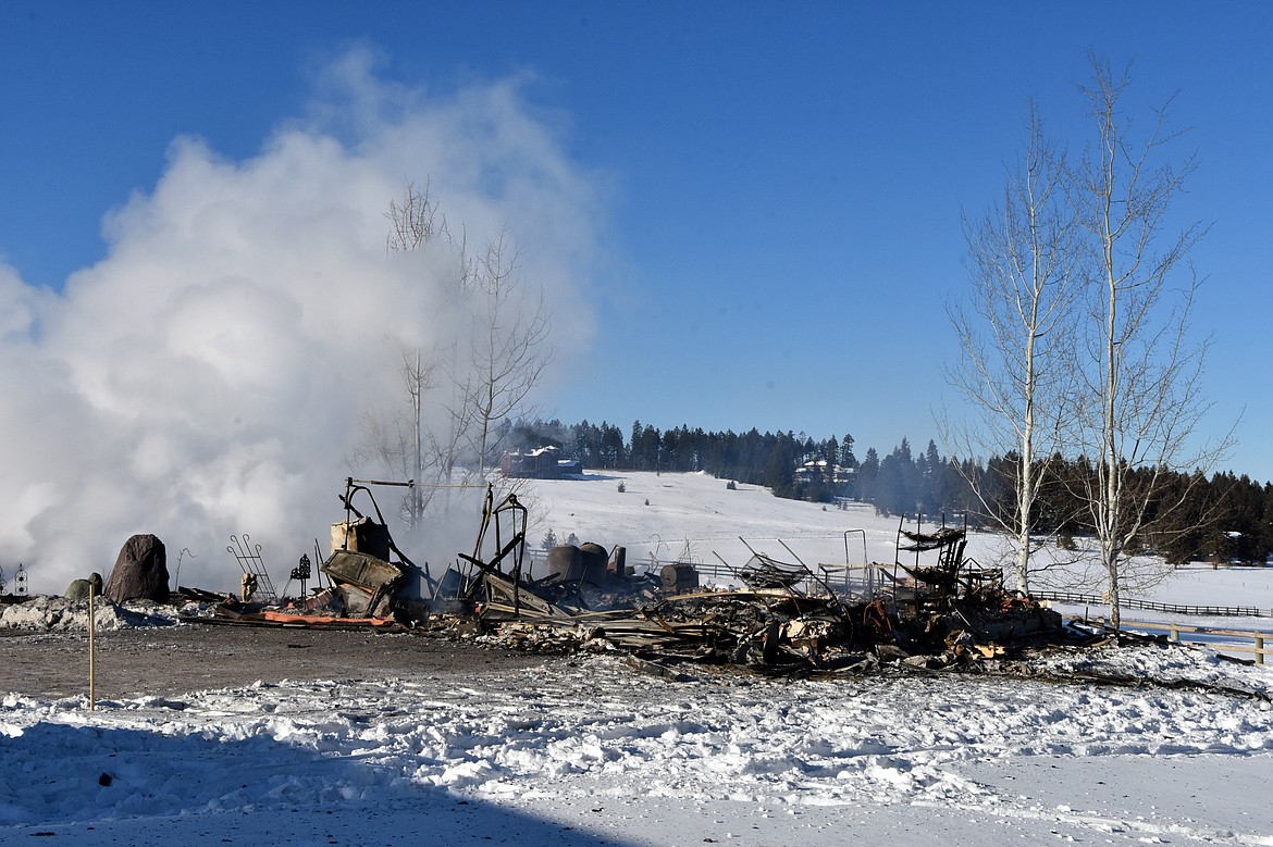 Steam rises up from the remains of Jerri Swenson&#146;s home that was destroyed by fire last January. (Heidi Desch / Whitefish Pilot file)