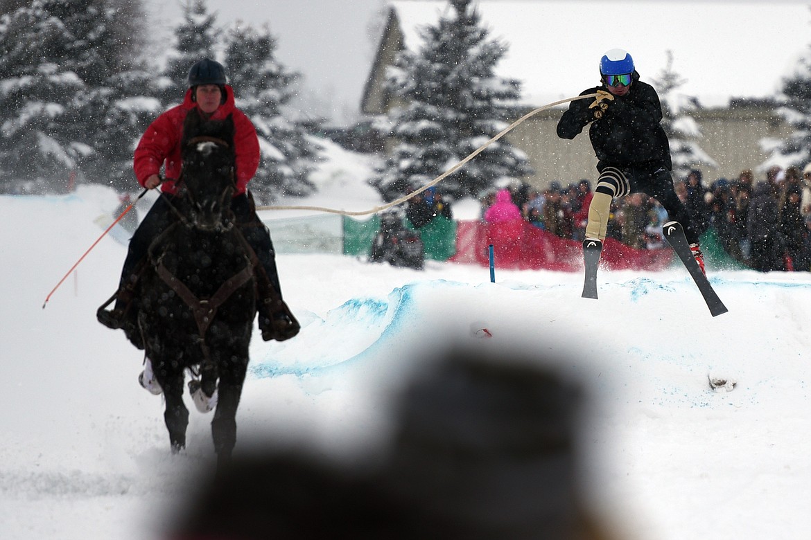 A horse and rider pulls a skier through the skijoring course at Rebecca Farm on Saturday, Dec. 30. (Casey Kreider/Daily Inter Lake)