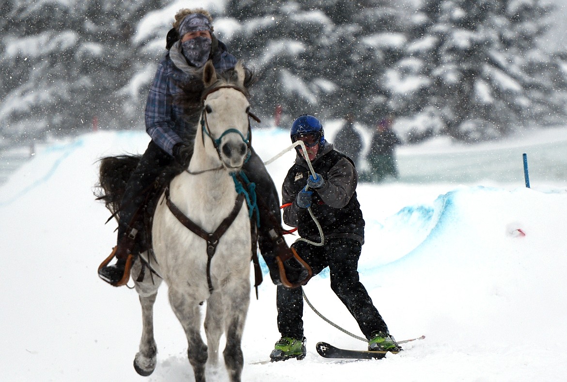 A horse and rider pulls a skier through the skijoring course at Rebecca Farm on Saturday, Dec. 30. (Casey Kreider/Daily Inter Lake)