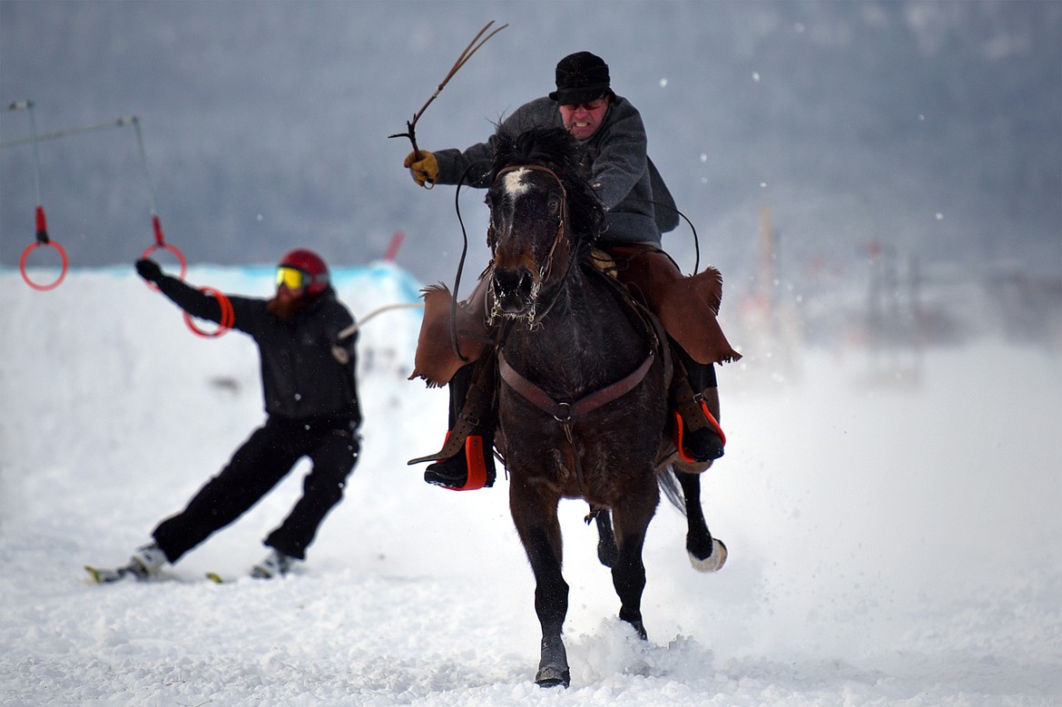 A horse and rider pulls a skier through the skijoring course at Rebecca Farm on Saturday, Dec. 30. (Casey Kreider/Daily Inter Lake)