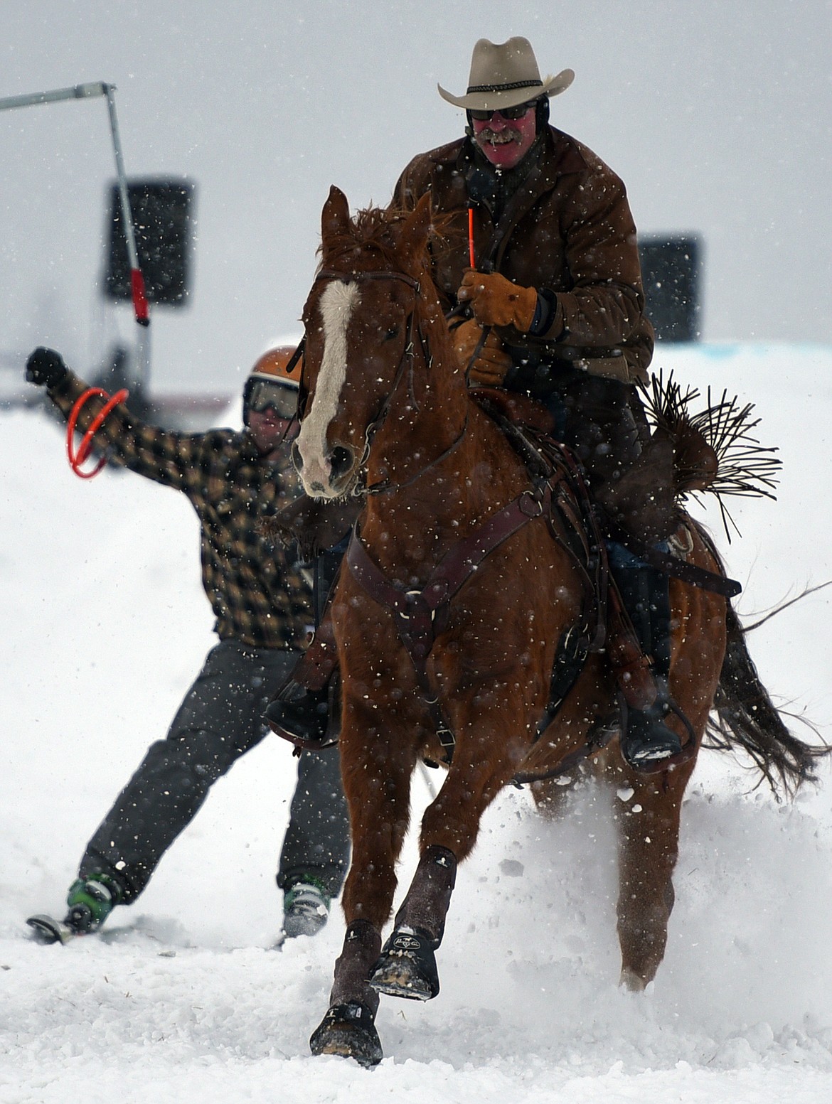 A horse and rider pulls a skier through the skijoring course at Rebecca Farm on Saturday, Dec. 30. (Casey Kreider/Daily Inter Lake)