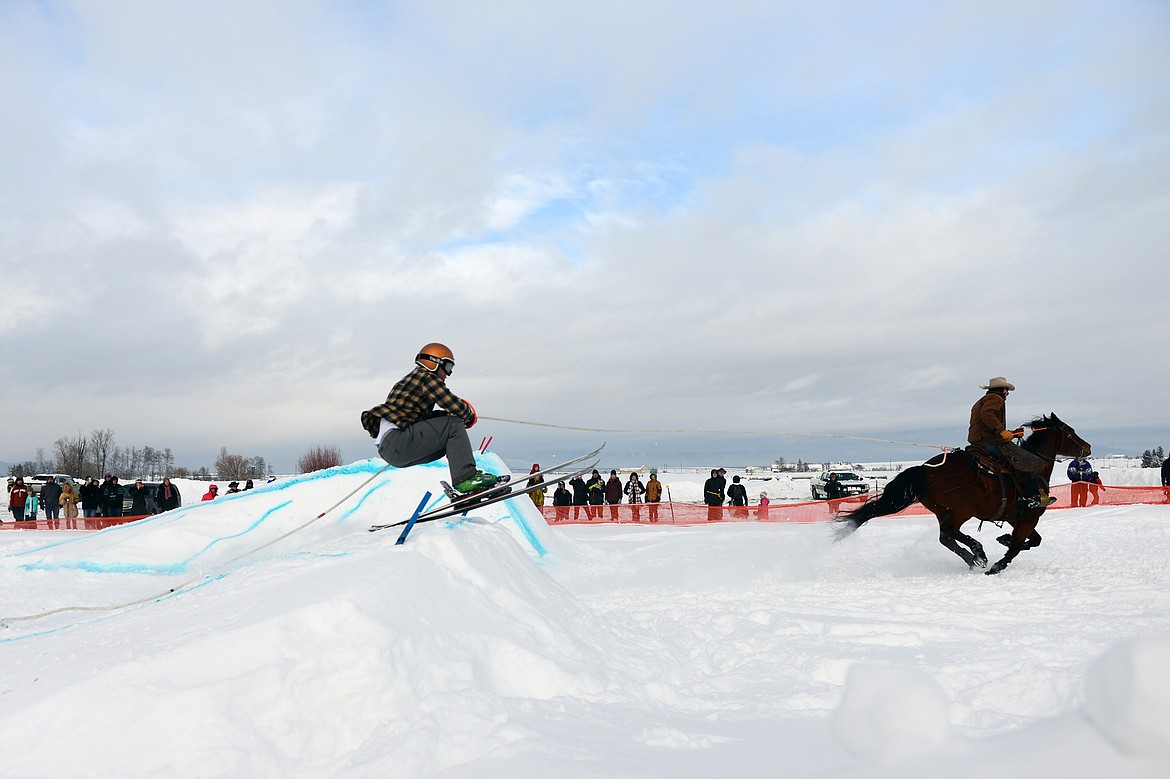 A horse and rider pulls a skier through the skijoring course at Rebecca Farm on Saturday, Dec. 30. (Casey Kreider/Daily Inter Lake)