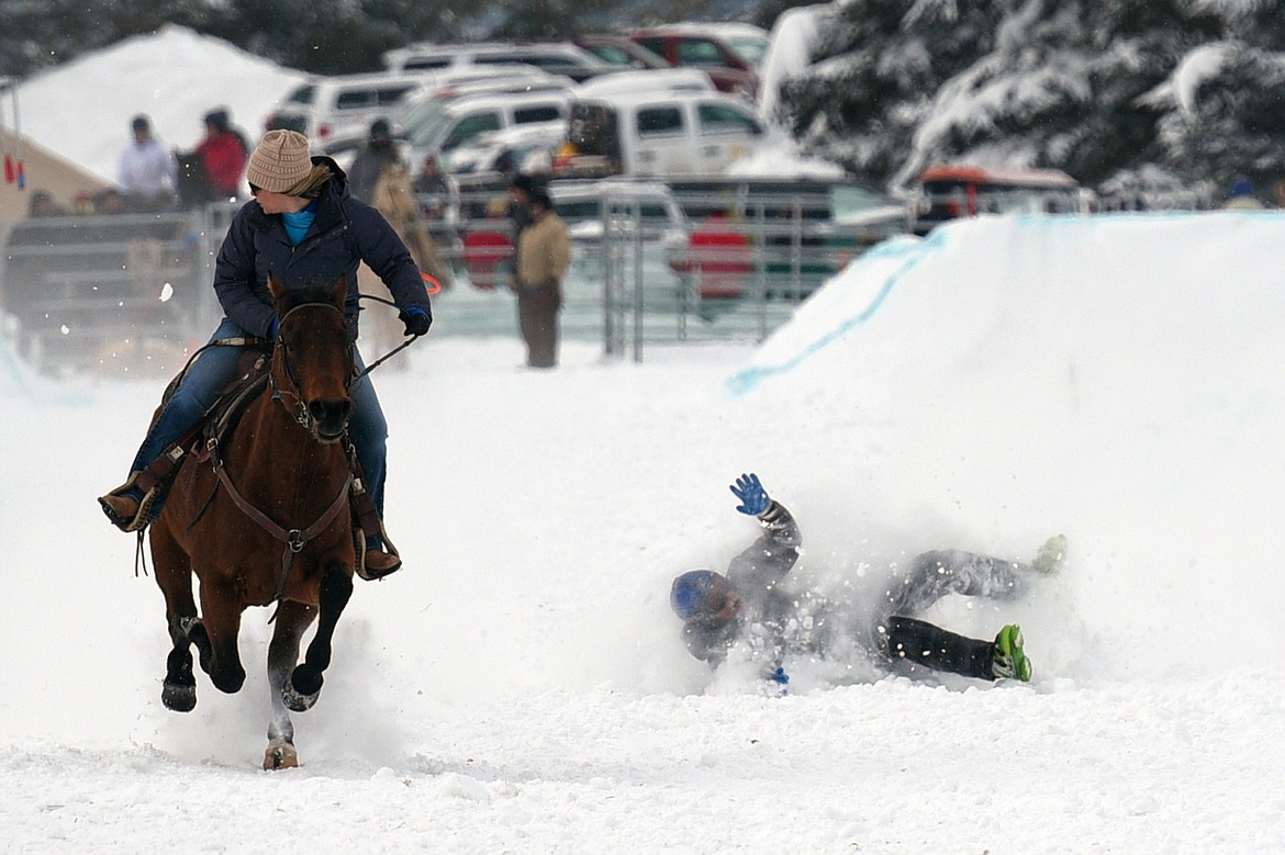 A skier crashes while being pulled through the skijoring course at Rebecca Farm on Saturday, Dec. 30. (Casey Kreider/Daily Inter Lake)