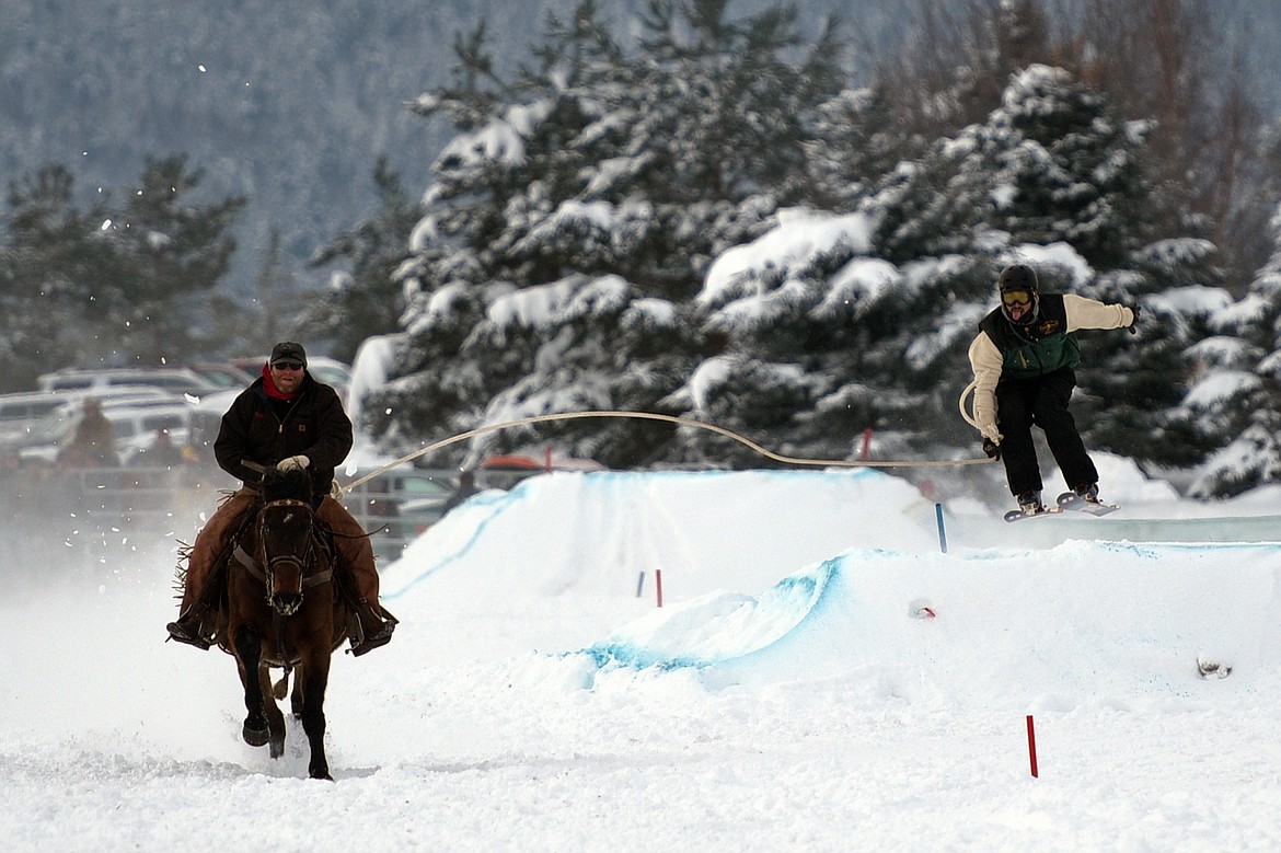 A horse and rider pulls a skier through the skijoring course at Rebecca Farm on Saturday, Dec. 30. (Casey Kreider/Daily Inter Lake)