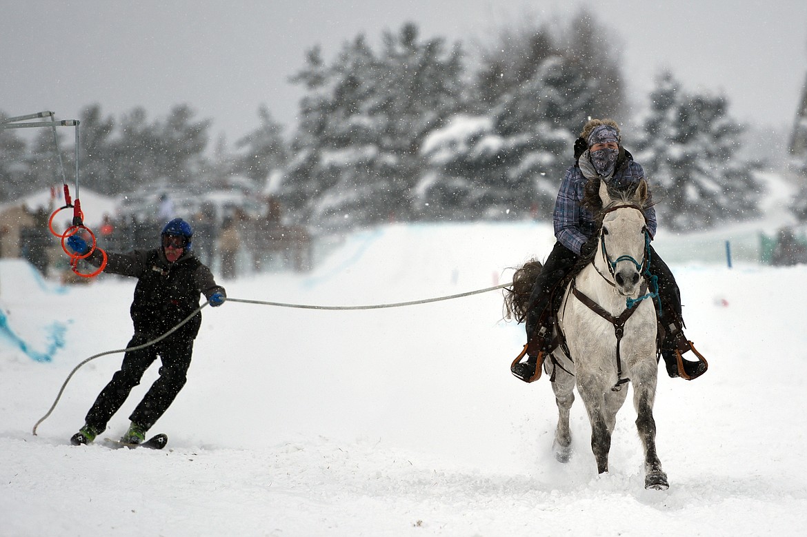 A horse and rider pulls a skier through the skijoring course at Rebecca Farm on Saturday, Dec. 30. (Casey Kreider/Daily Inter Lake)