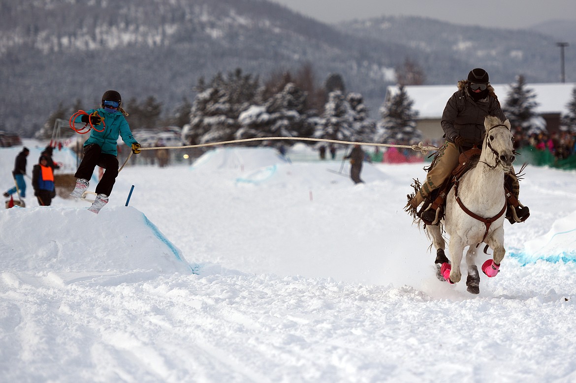 A horse and rider pulls a skier through the skijoring course at Rebecca Farm on Saturday, Dec. 30. (Casey Kreider/Daily Inter Lake)