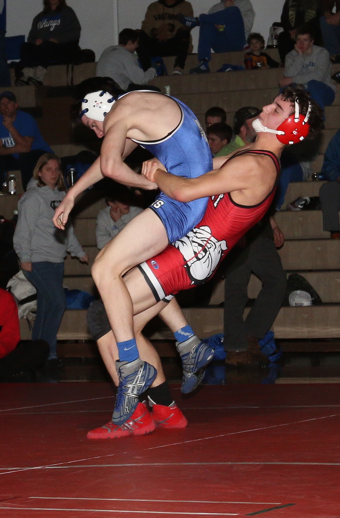 (Photo by ERIC PLUMMER)
Sandpoint&#146;s Brady Nelson throws Coeur d&#146;Alene&#146;s Garrett Ashby in the Bulldogs home opener Friday night.