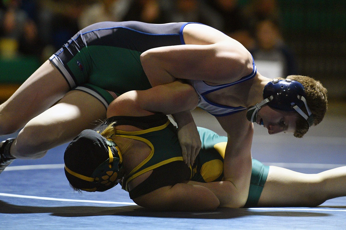 Glacier&#146;s Caden Willis works toward a pin against Whitefish&#146;s Sidney Cooke at 132 pounds. (Casey Kreider/Daily Inter Lake)