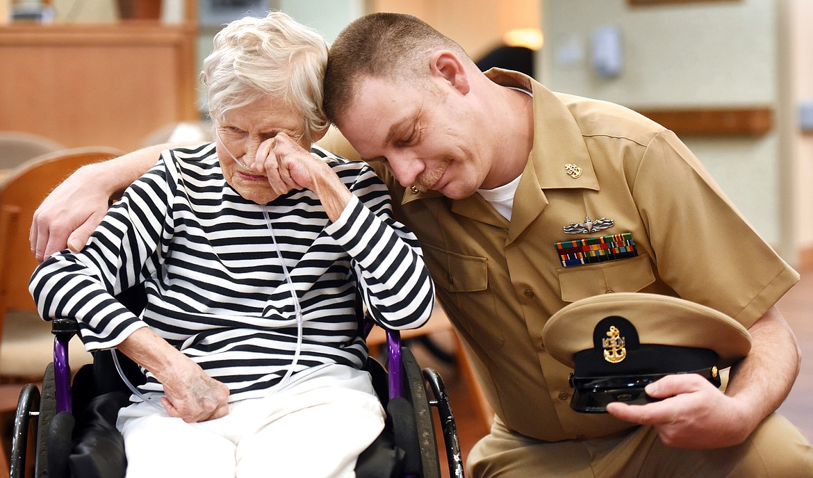 Carroll Krause weeps as she gets a hug from her grandson, Chief Petty Officer Anthony Fluke, as he makes good on his promise to someday come home from the Navy wearing his dress uniform on April 10, at Brendan House in Kalispell. Fluke planned to retire after 20 years of service.