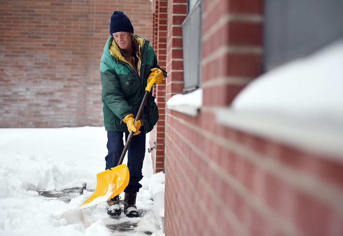 Gary Rhodes shovels snow from around the Samaritan House on Thursday in Kalispell. Rhodes, who is homeless, noticed that the Samaritan House had an extra snow shovel and asked if he could borrow it to see if he could earn some money by shoveling sidewalks. Chris Krager, executive director, was so pleased with Rhodes&#146; attitude that he not only agreed to loan him a shovel he said Samaritan House would be his first customer. (Brenda Ahearn/Daily Inter Lake)