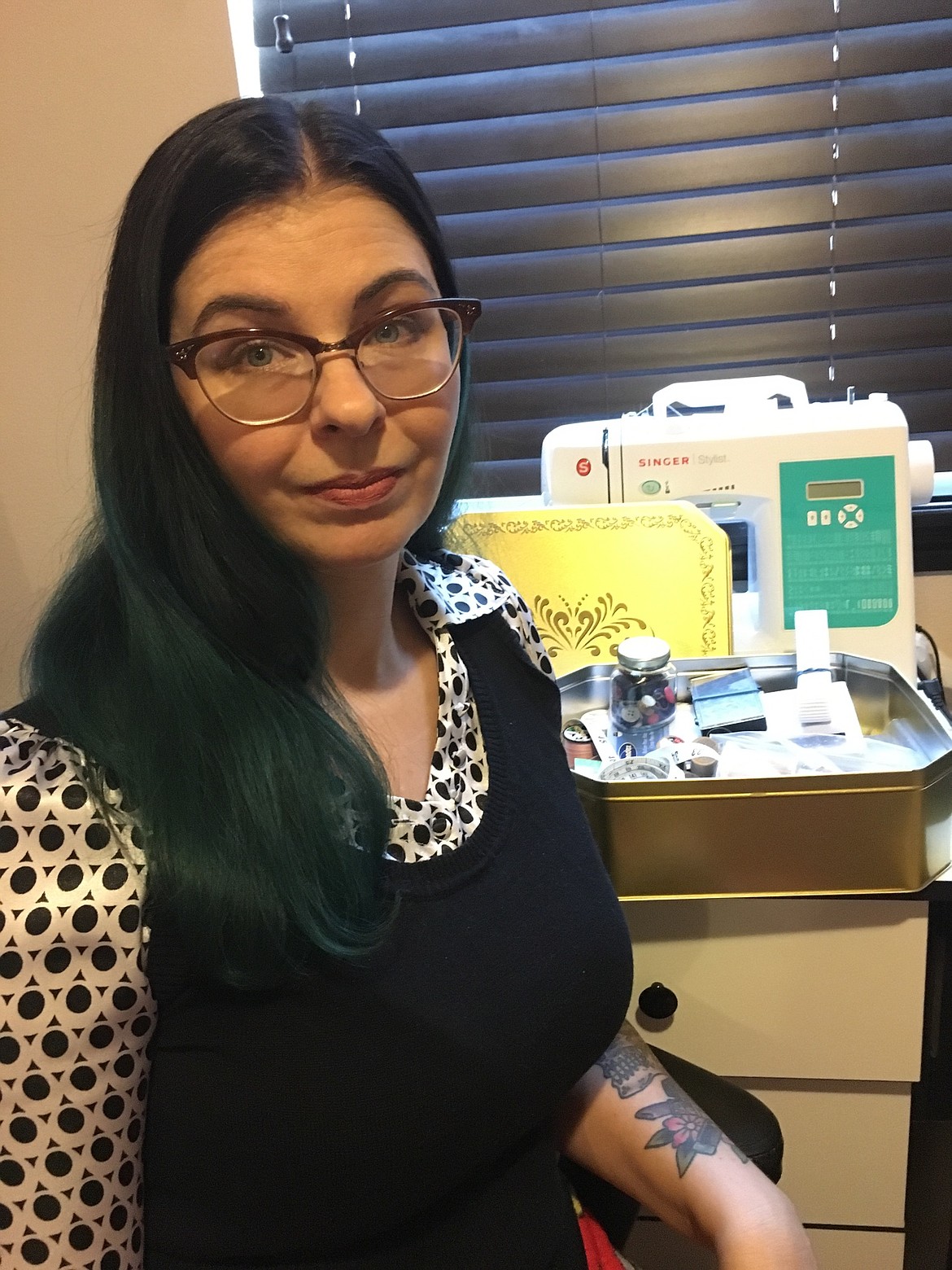 Courtesy photo
Erin Looney, of Post Falls, stands Thursday with a sewing kit she found in a Spokane thrift store during a recent lunch break. The kit belonged to her mom, who died in 1998. Looney said she was drawn to the gold box and could not believe it still contained specific items that it held while her mom was alive, despite being sold with a storage unit and disappearing for nearly 20 years.