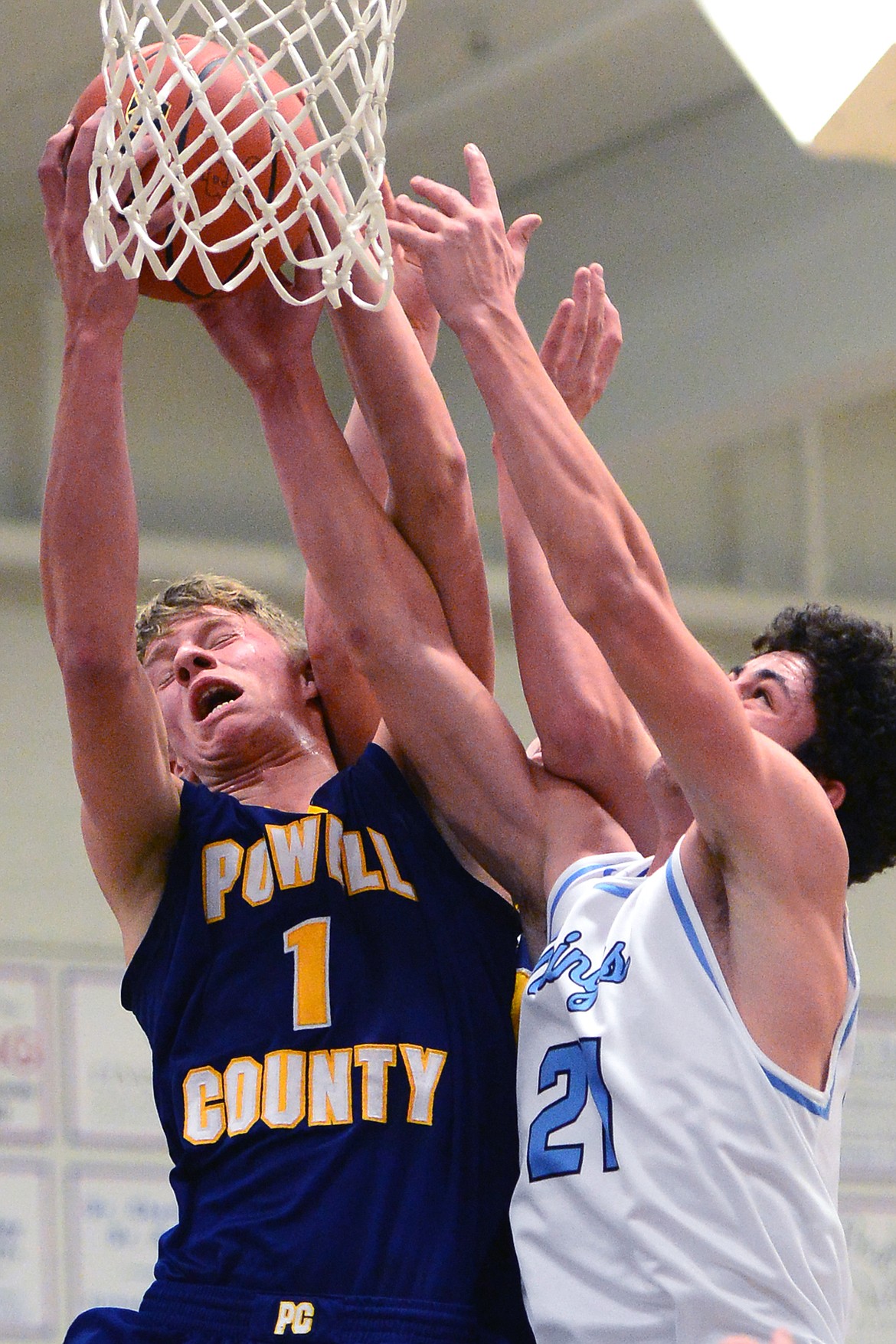 Deer Lodge's Ben Anderson fights for a rebound against Bigfork's Chase Chappius. (Casey Kreider/Daily Inter Lake)