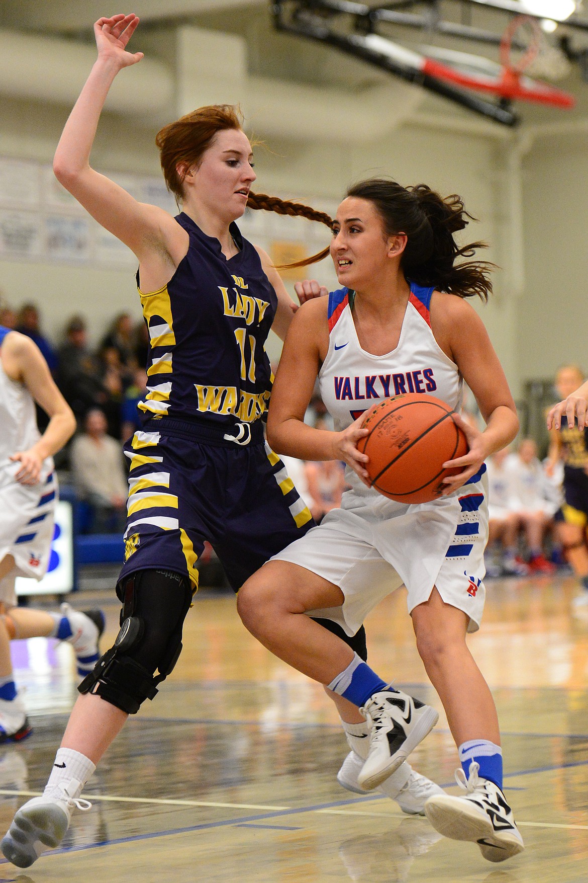 Bigfork's Abby Lembke drives to the hoop with Deer Lodge's Darcy Walker defending. (Casey Kreider/Daily Inter Lake)