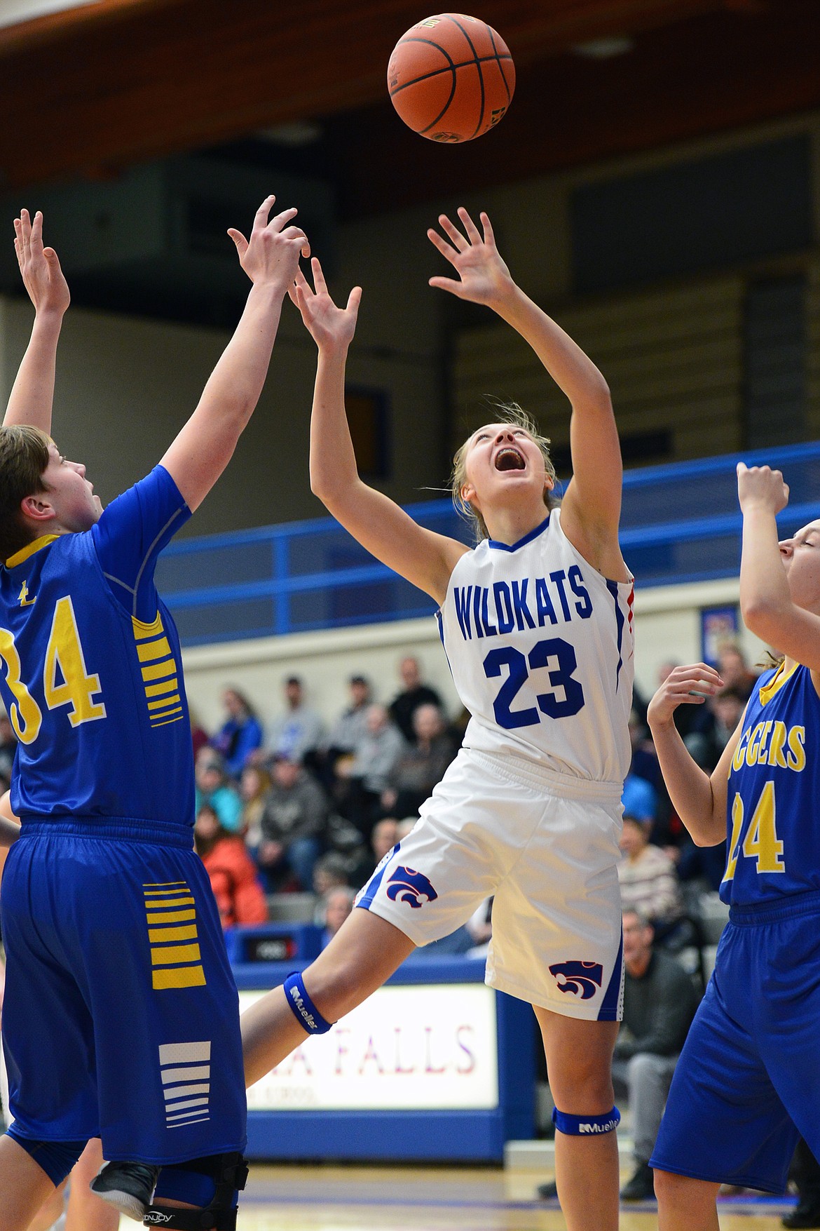 Columbia Falls' Ryley Kehr shoots between Libby defenders Shannon Reny, left, and Jayden Winslow. (Casey Kreider/Daily Inter Lake)