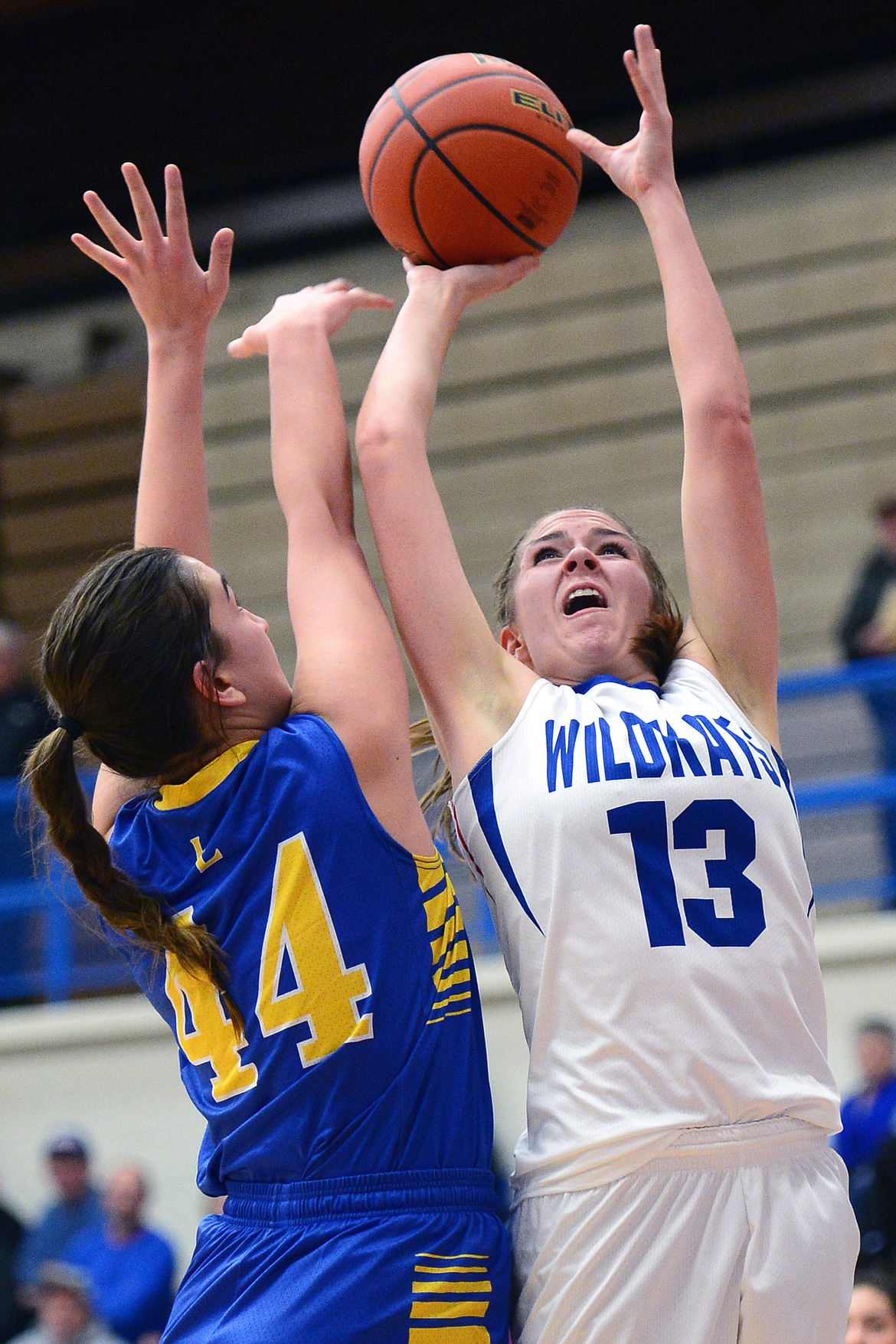 Columbia Falls' Hannah Gedlaman looks to shoot over Libby defender Brooklyn Rainer. (Casey Kreider/Daily Inter Lake)