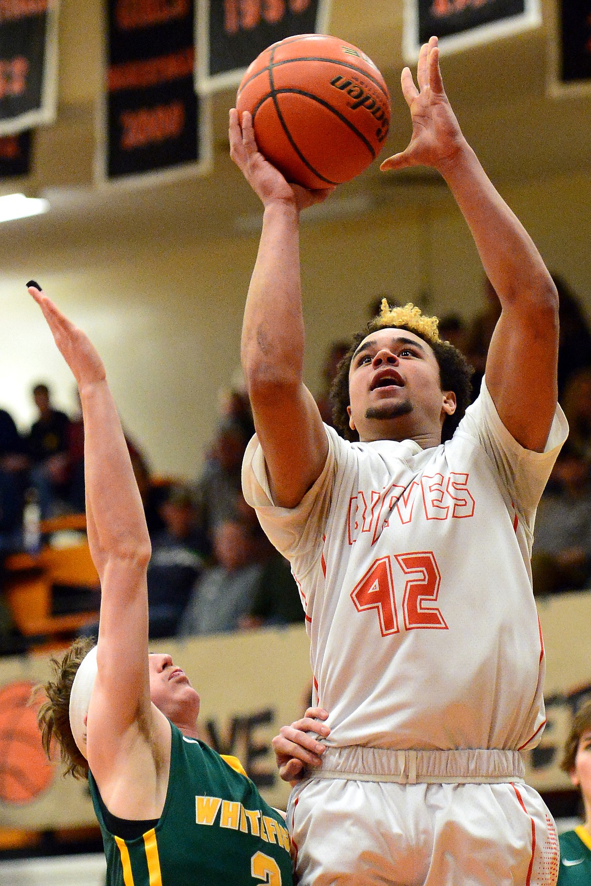 Flathead&#146;s Anthony Jones goes to the hoop over Whitefish defender Caleb Meehan. (Casey Kreider/Daily Inter Lake)