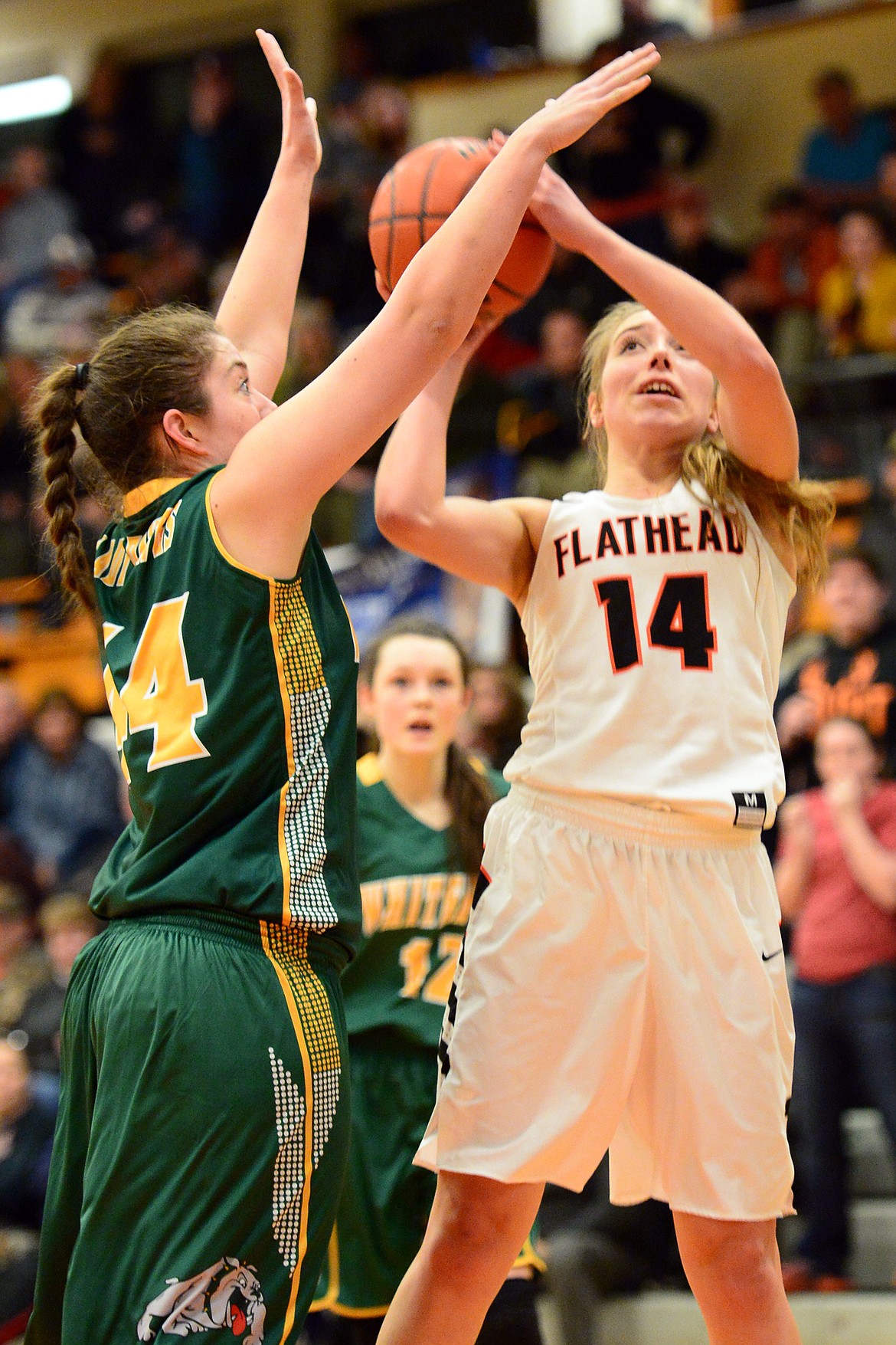 Flathead&#146;s Mary Heaton scores two points in overtime against Whitefish defender Marlee Bender. (Casey Kreider/Daily Inter Lake)