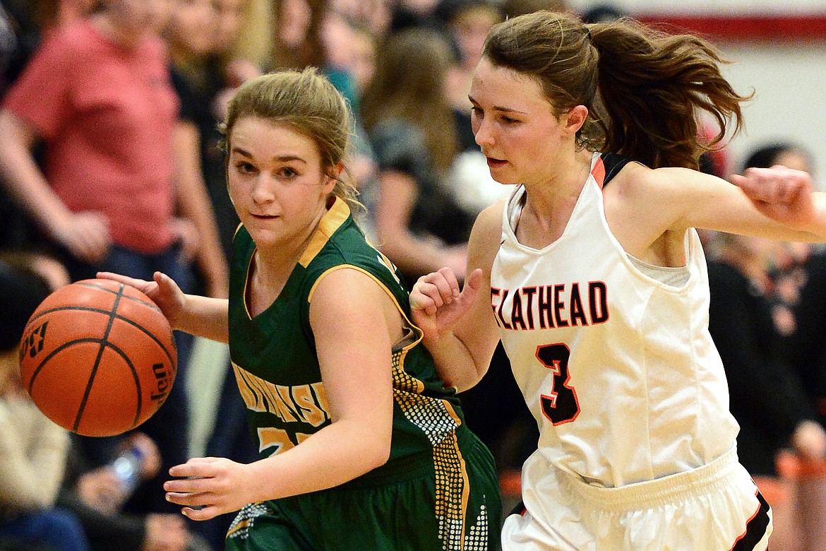 Whitefish guard Ashton Ramsey brings the ball upcourt with Flathead&#146;s Sadie Wilson defending. (Casey Kreider/Daily Inter Lake)