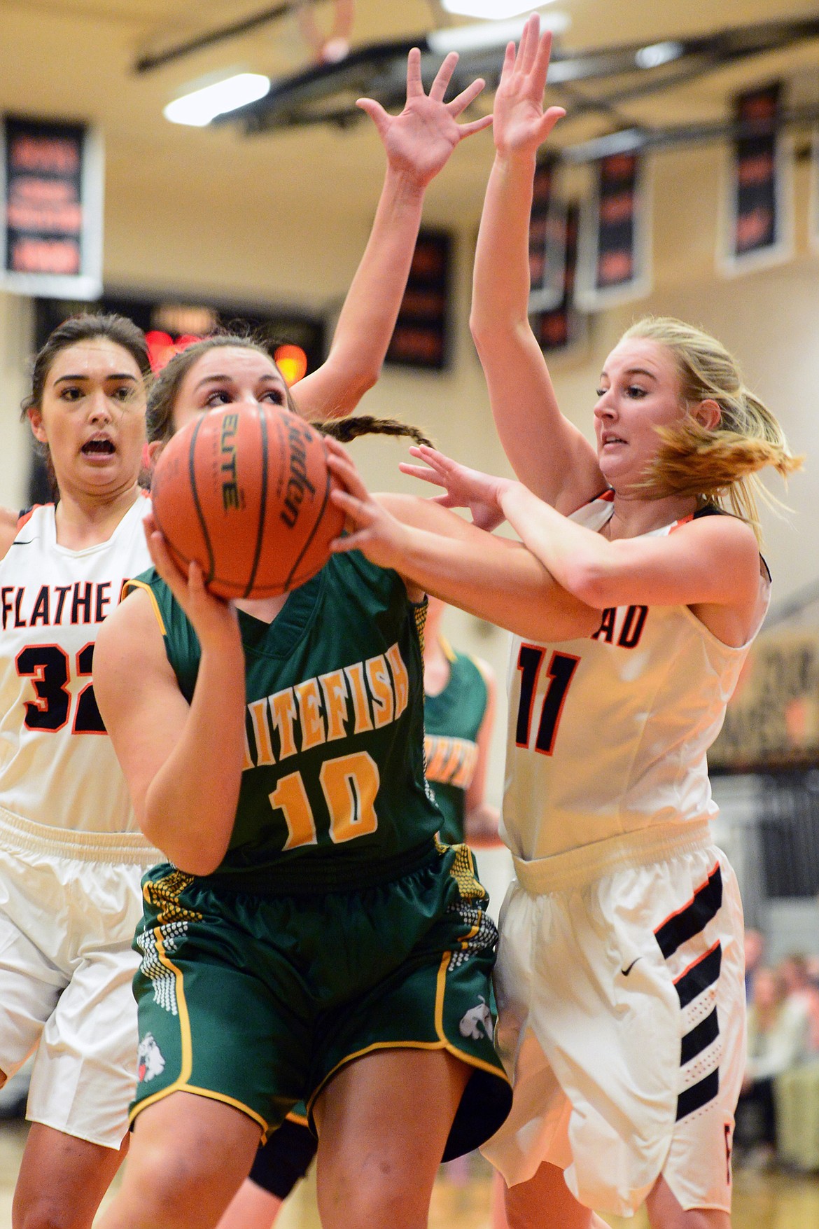 Whitefish&#146;s Hope Brown looks to shoot with Flathead&#146;s Taylor Henley, left, and Kaysie Malmin defending. (Casey Kreider/Daily Inter Lake)