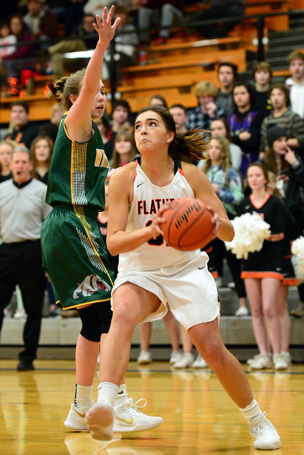 Flathead&#146;s Taylor Henley drives to the hoop around Whitefish defender Kit Anderson. (Casey Kreider/Daily Inter Lake)