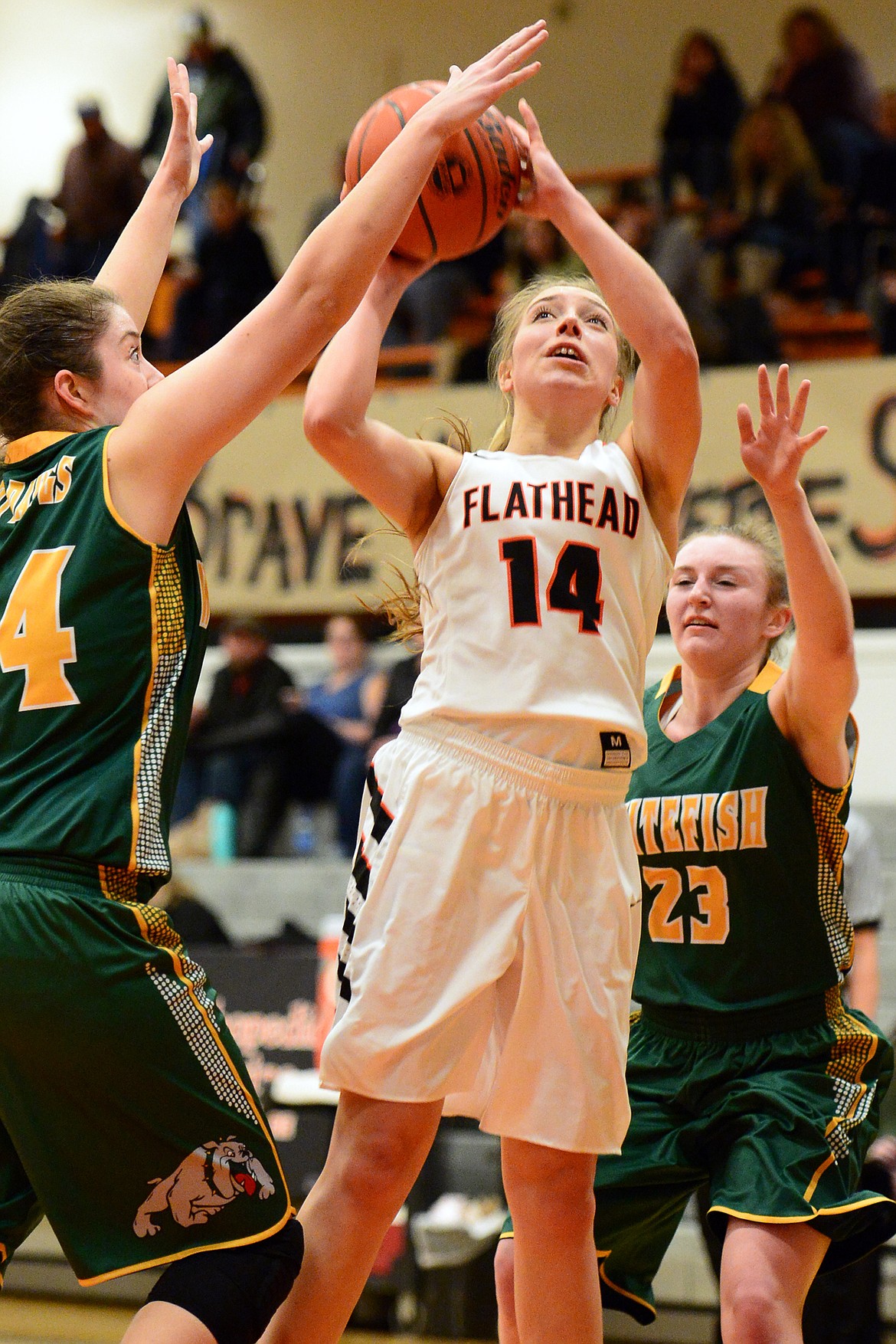 Flathead&#146;s Mary Heaton shoots between Whitefish defenders Marlee Bender, left, and Annisa Brown. (Casey Kreider/Daily Inter Lake)