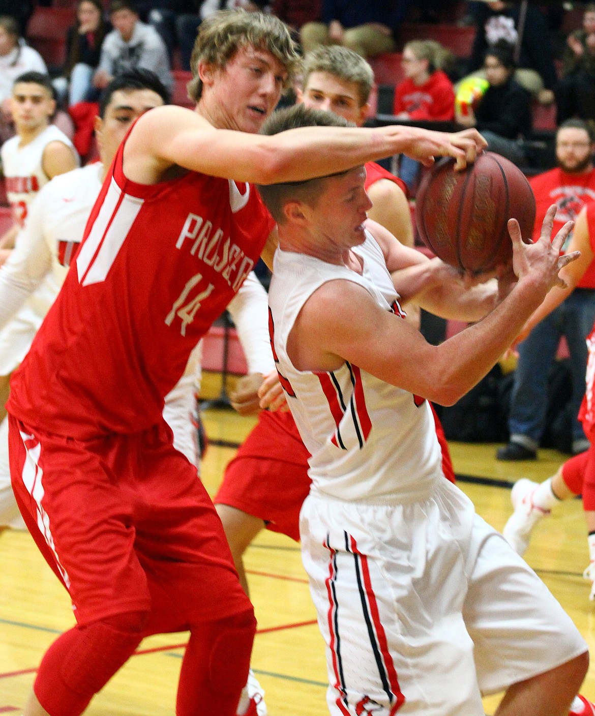 Rodney Harwood/Columbia Basin HeraldOthello senior Trevor Hilmes (32) battles Prosser's Calvin Maljaars (14) for a rebound in Friday's CWAC game that was decided in the third overtime period.