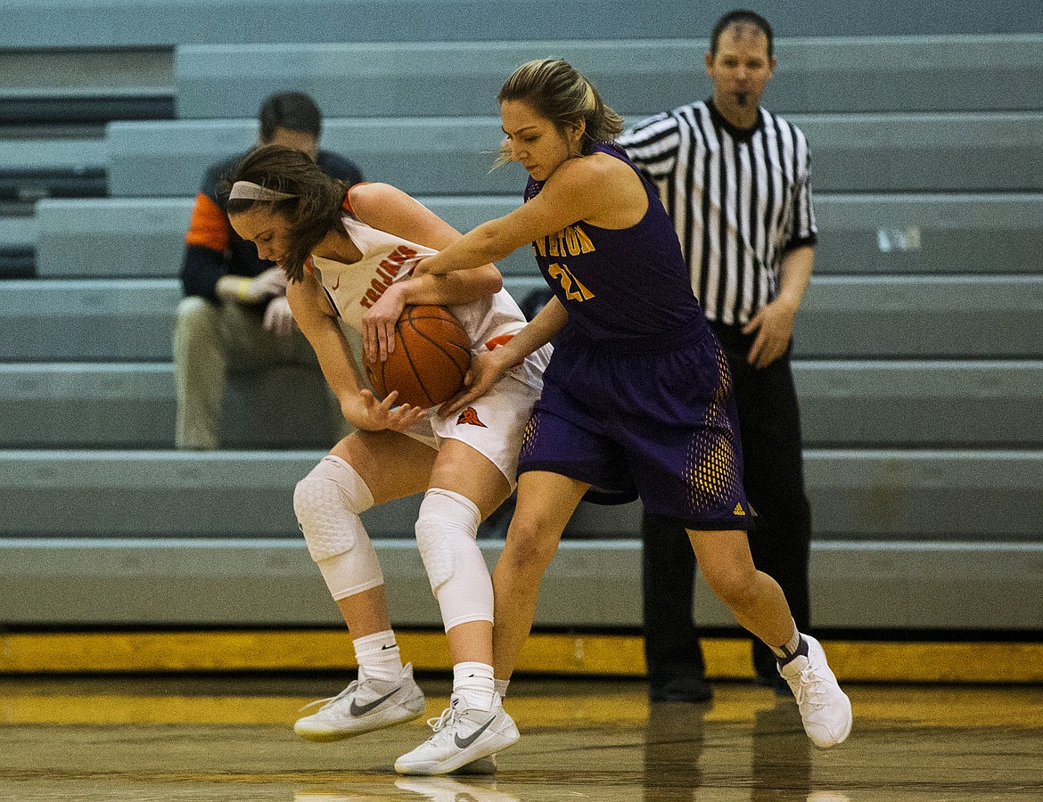 Post Falls guard Jackson McCliment-Call wrestles the ball away from Lewiston&#146;s Maya Eke during Tuesday night&#146;s game at Post Falls High School. (LOREN BENOIT/Press)