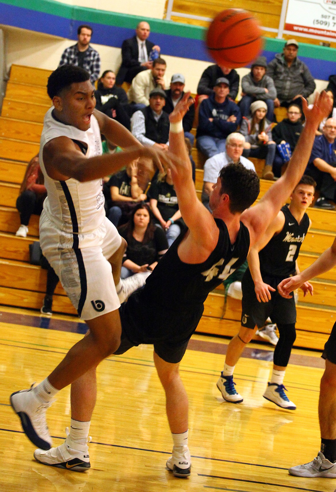 Rodney Harwood/Columbia Basin Herald
Big Bend forward Mauricio Smith draws a foul on Justin Dorius of Wenatchee Valley Wednesday night during NWAC East action at DeVries Activity Center.