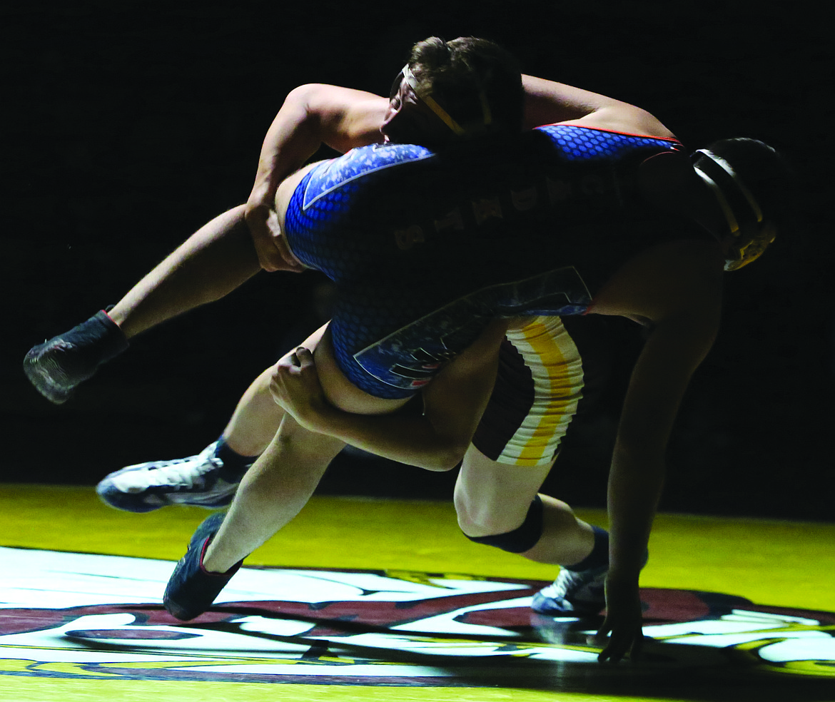 Connor Vanderweyst/Columbia Basin Herald
Moses Lake's BJ Mullin takes down Eisenhower's Michael Edmonds in the 160-pound match.