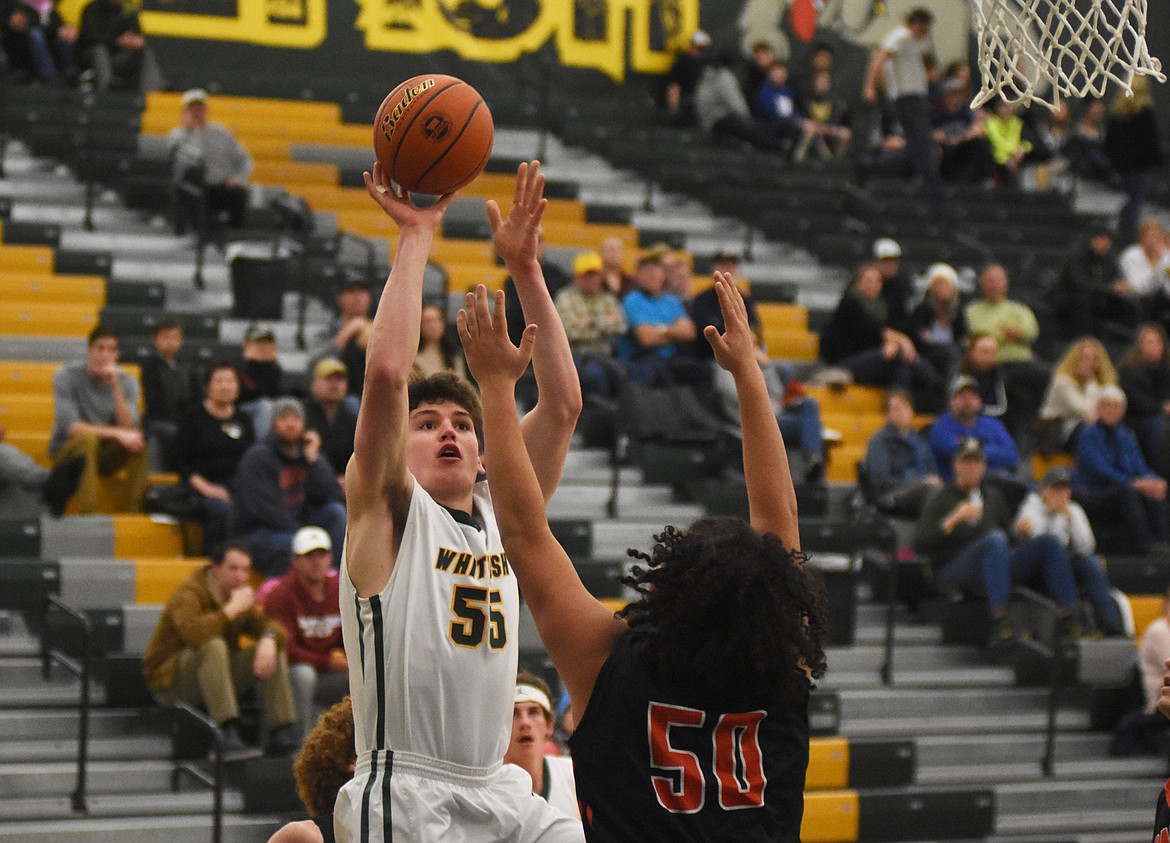 Bulldog Dillon Botner fades away from a Ronan defender last week in the gym at Whitefish High School. (Daniel McKay/Whitefish Pilot)