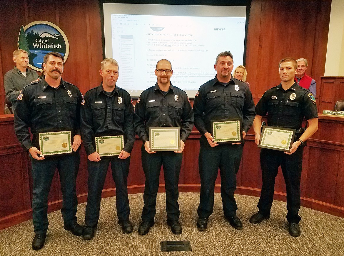 Whitefish firefighters Captain Joe Rendahl, Mike Zorn, Cole Hadley, and Cole Lackey and police officer Trey Nasset were all honored by the Whitefish City Council. (Photo courtesy Adam Hammatt)