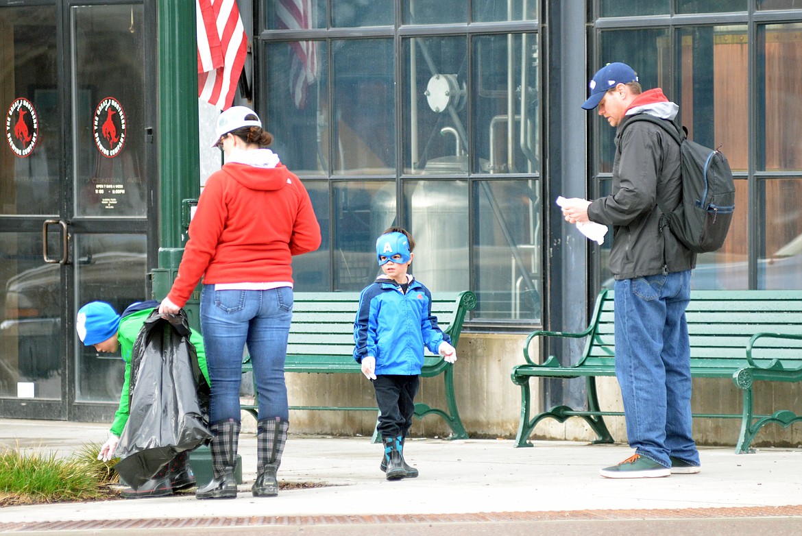 Colter Tate, center, looks for trash along with his family Henry, Heidi and Casey Tate on Central Avenue during the annual Clean the Fish in April. The Tate family was just one of many folks who spent a Saturday cleaning their town.