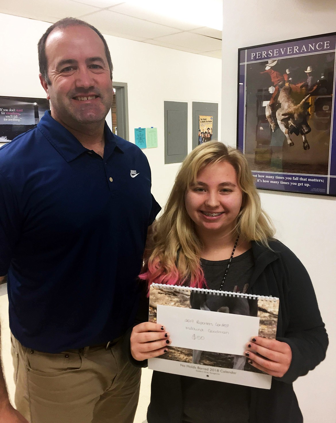 Melaina Goodman (right) with Thompson Falls High School Principal Rich Ferris. Goodman recieved her winnings as a finalist of the Clark Fork Valley Press 2017 Reporters Contest (Erin Jusseaume/ Clark Fork Valley Press)