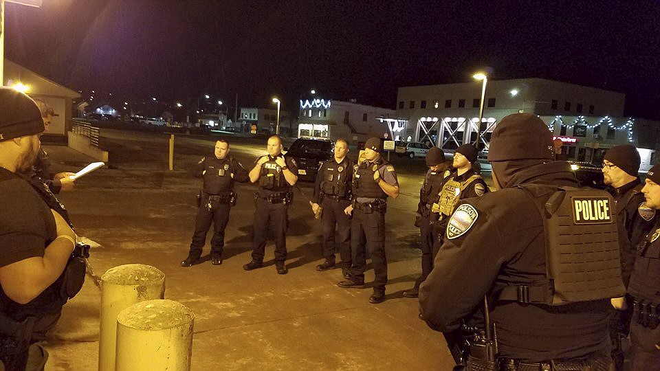 Officers from the Polson Police Department and Flathead Tribal Police Department prepare for a raid on Dec. 18, where six children were taken into protective custody from four undisclosed locations in Polson city limits. (Photo courtesy of Polson Police Department)